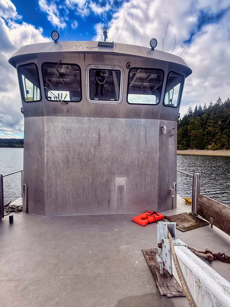 Slide: The Image of The image shows a sturdy aluminum boat with an enclosed cabin and life jackets on deck. - 17