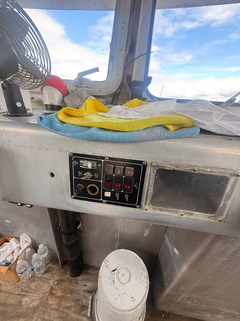 Slide: The Image of Interior view of a boat with aluminum paneling, control panel, and a fan. - 7