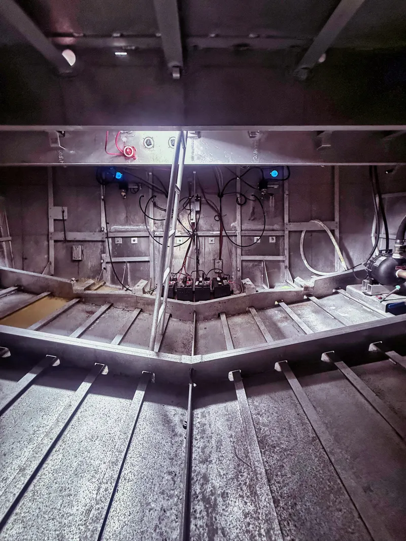 Slide: The Image of Interior view of an aluminum boat with visible wiring and structural elements. - 12