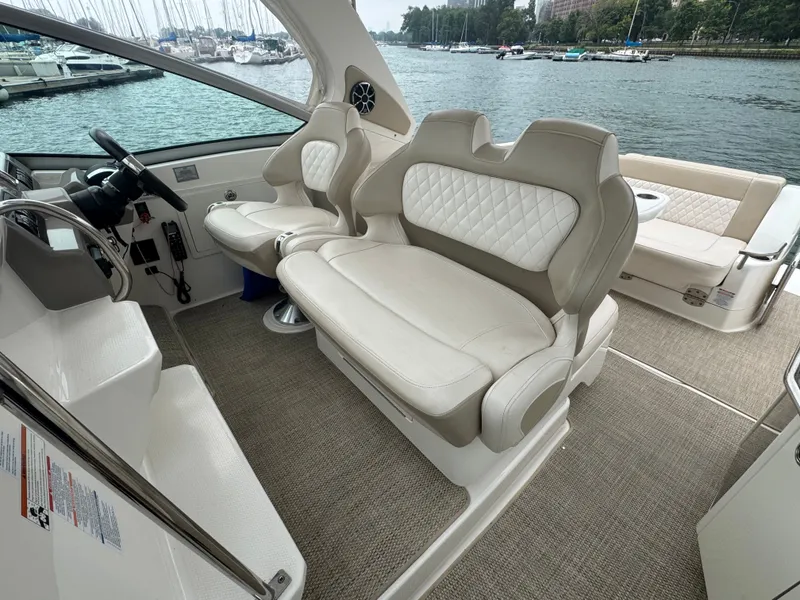 Slide: The Image of The image shows the cockpit of a 2018 Chaparral 330 Signature with beige leather seats. - 8