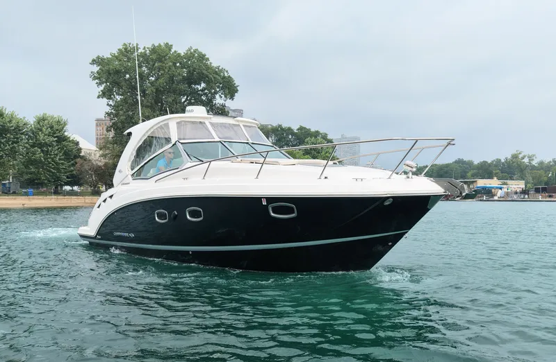 Slide: The Image of A 2018 Chaparral 330 Signature cruising on calm water. It features a sleek, modern design. - 1