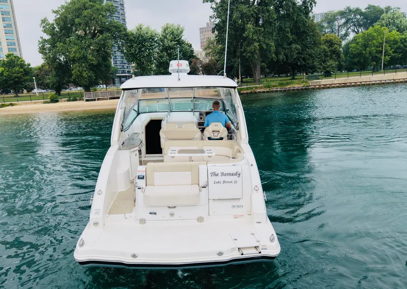 Slide: The Image of A 2018 Chaparral 330 Signature cruising on calm waters, surrounded by trees. - 2