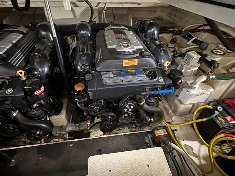Slide: The Image of The engine room of a 2018 Chaparral 330 Signature with two large engines and various hoses and cables. - 17