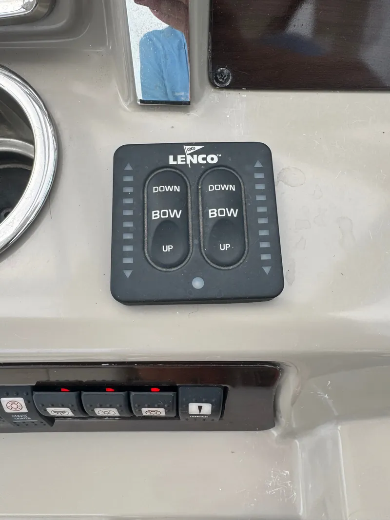 Slide: The Image of Close-up of the control console with Lenco trim tab controls and switches. - 11