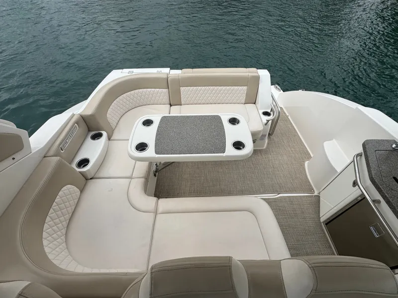 Slide: The Image of The image shows the cockpit of a 2018 Chaparral 330 Signature with beige upholstery and a table. - 6