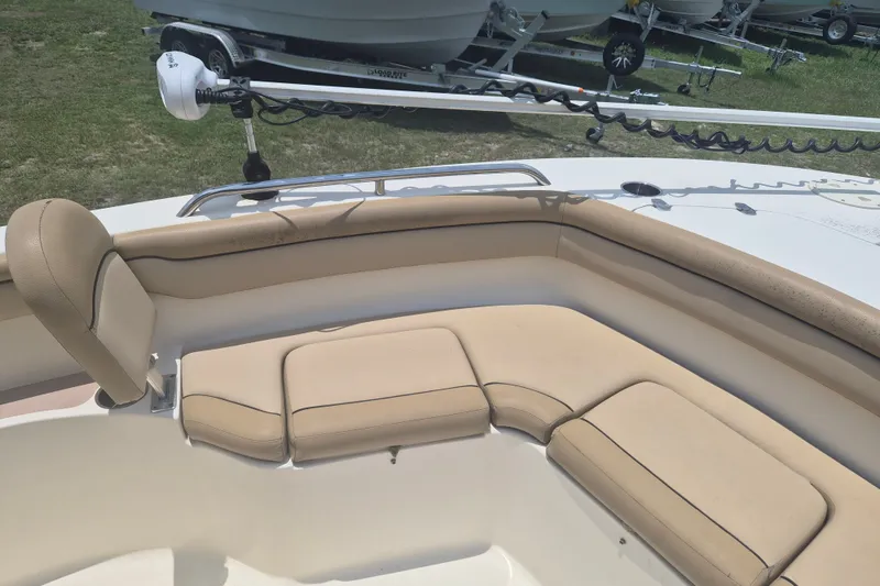 Slide: The Image of 2017 Scout 215 XSF boat interior with beige seating and trolling motor. - 26