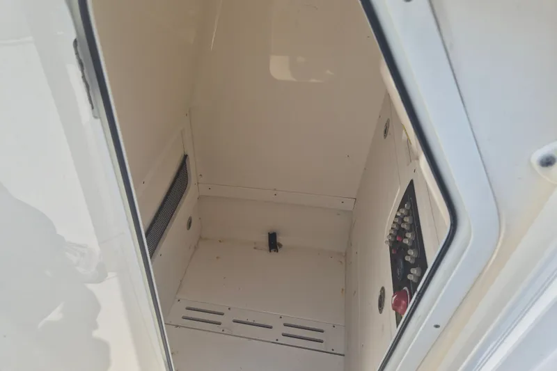 Slide: The Image of 2017 Scout 215 XSF boat interior storage compartment with control panel. - 20