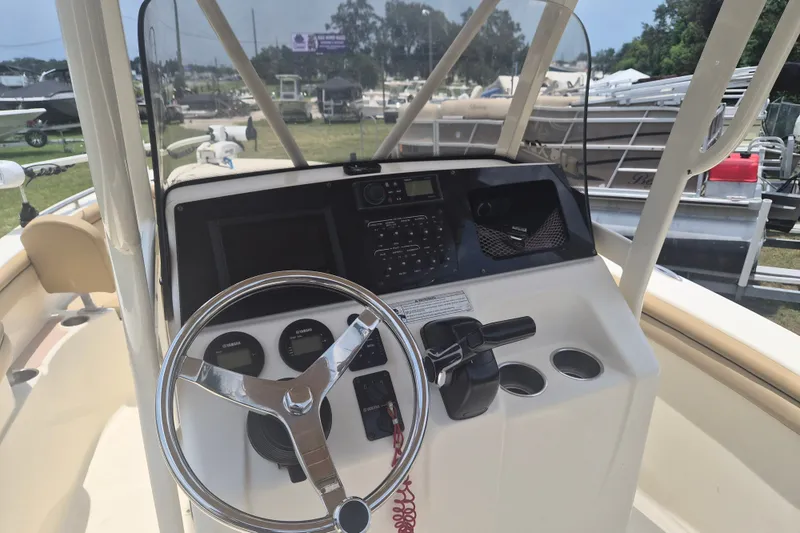 Slide: The Image of 2017 Scout 215 XSF boat dashboard with steering wheel and control panel. - 15