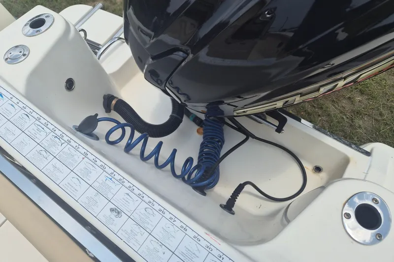 Slide: The Image of 2017 Scout 215 XSF boat engine area with coiled hose and measurement guide. - 9