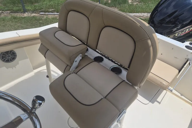 Slide: The Image of 2017 Scout 215 XSF boat interior with beige seating and cup holders. - 14