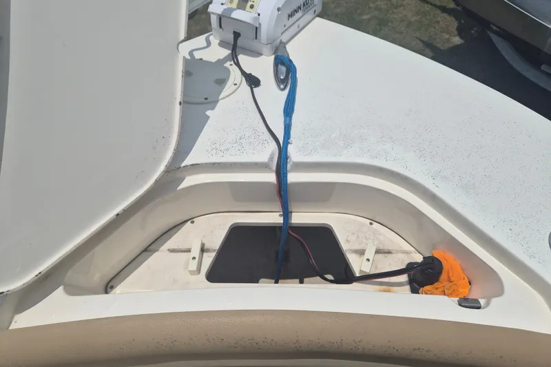 Slide: The Image of Open storage compartment on 2017 Scout 215 XSF boat with wiring and equipment. - 28