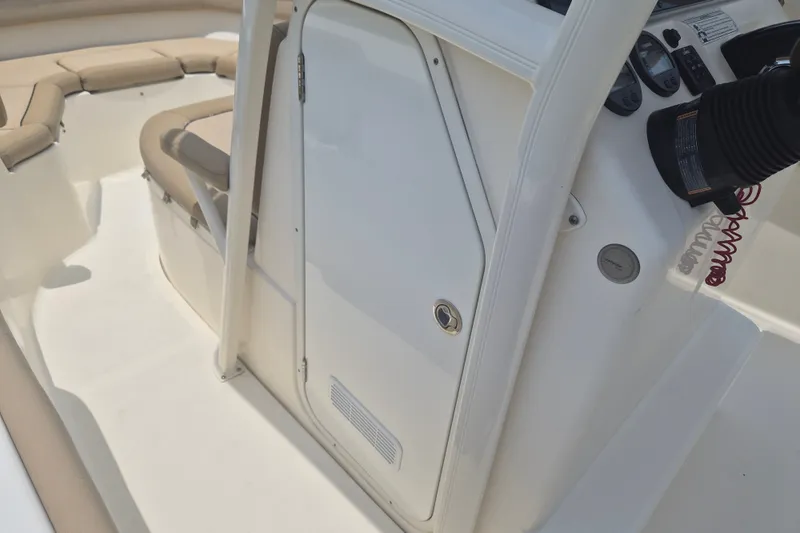 Slide: The Image of 2017 Scout 215 XSF boat interior with beige seating and control panel. - 19