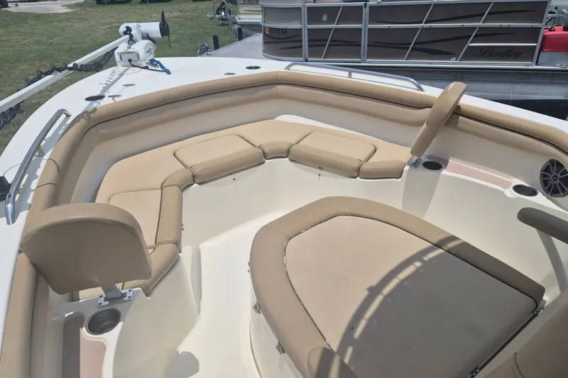Slide: The Image of 2017 Scout 215 XSF boat interior with beige seating and cup holders. - 21