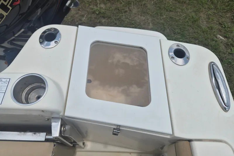 Slide: The Image of 2017 Scout 215 XSF boat deck with rod holders and storage compartment. - 8