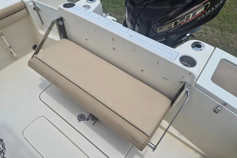 Slide: The Image of 2017 Scout 215 XSF boat with foldable beige seat and Yamaha engine. - 11