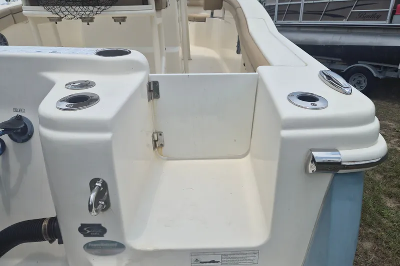 Slide: The Image of 2017 Scout 215 XSF boat interior with rod holders and seating area. - 6