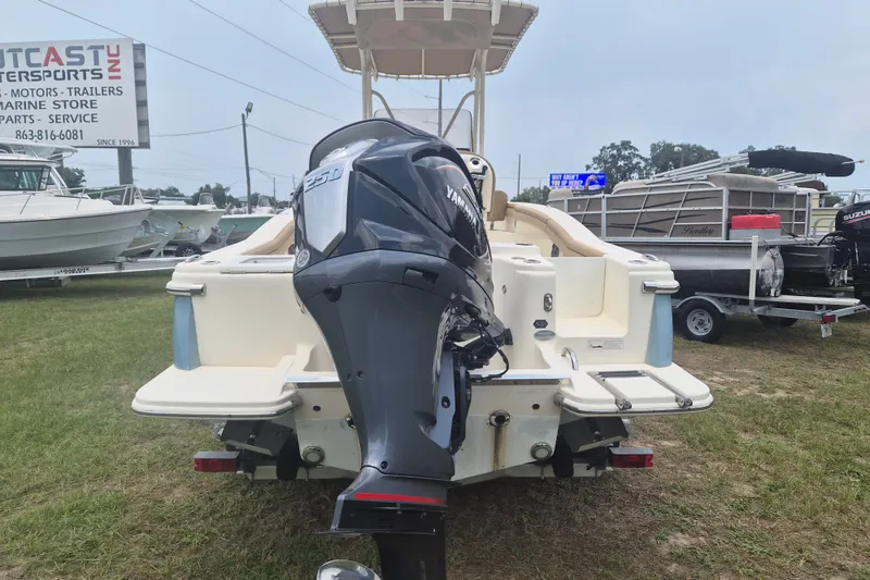 Slide: The Image of 2017 Scout 215 XSF boat with Yamaha outboard motor displayed outdoors. - 2