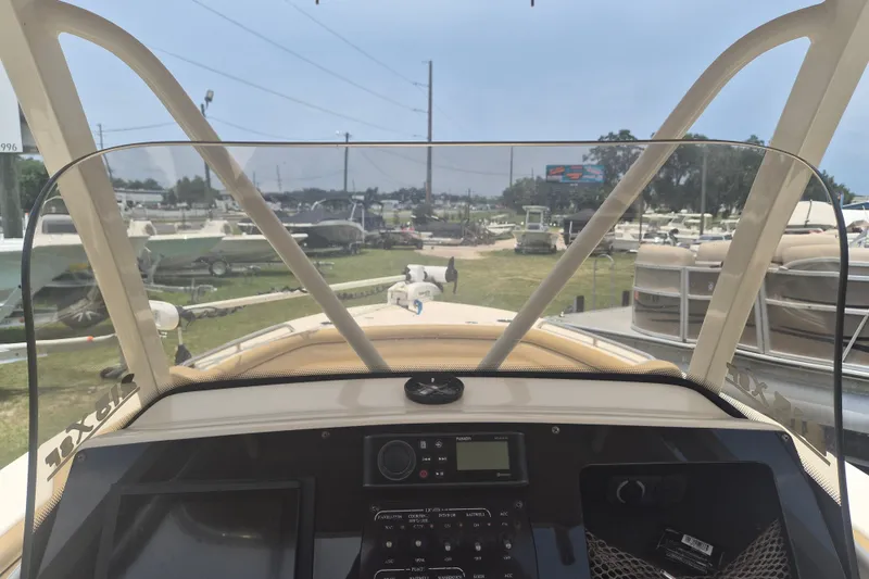 Slide: The Image of 2017 Scout 215 XSF boat dashboard view at a marina. - 17