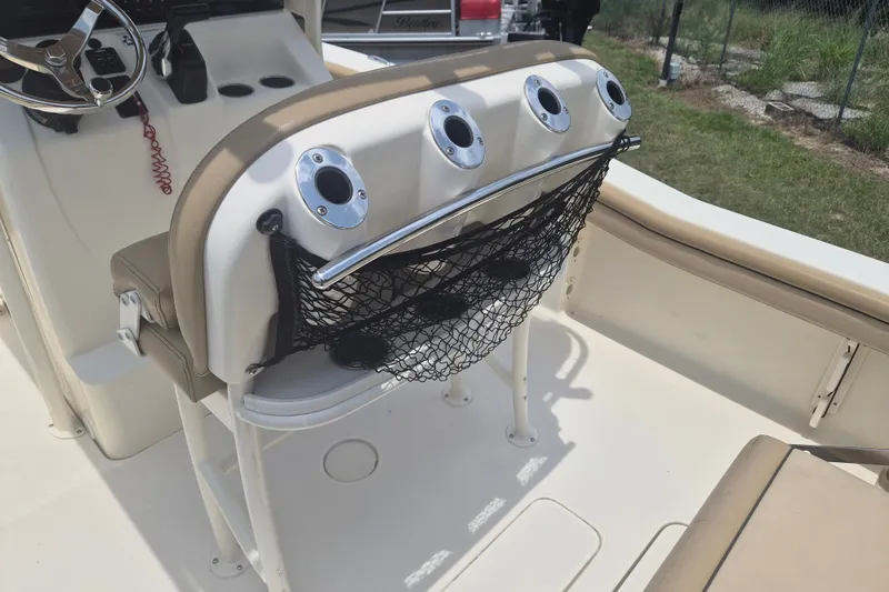 Slide: The Image of 2017 Scout 215 XSF boat interior with rod holders and net storage. - 12