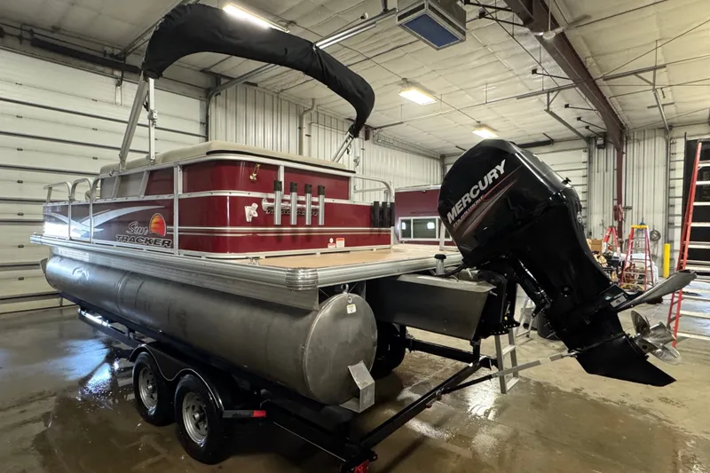Slide: The Image of 2014 Sun Tracker Party Barge 20 DLX pontoon boat with Mercury outboard motor in a garage. - 4
