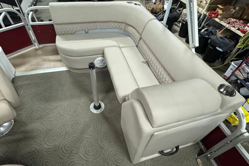 Slide: The Image of 2014 Sun Tracker Party Barge 20 DLX interior with beige seating and carpeted floor. - 7
