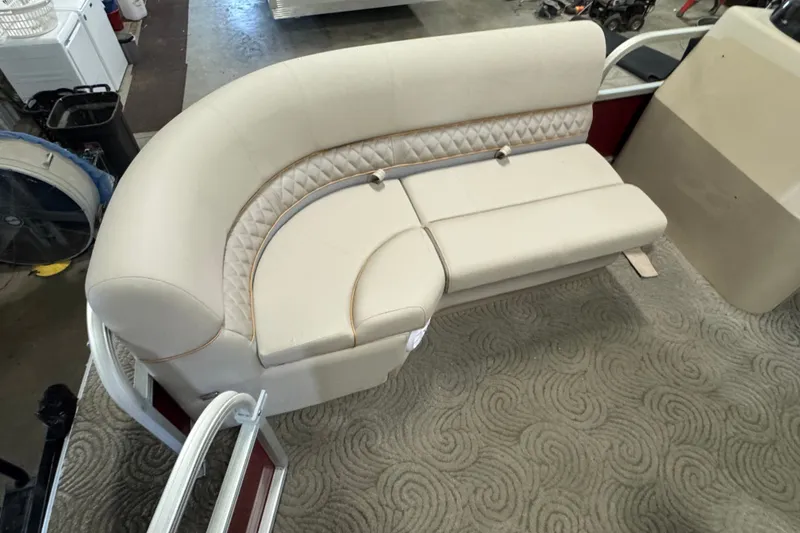 Slide: The Image of 2014 Sun Tracker Party Barge 20 DLX interior with beige seating and patterned carpet. - 6