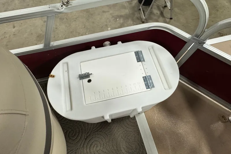 Slide: The Image of 2014 Sun Tracker Party Barge 20 DLX with white storage compartment and ruler. - 11