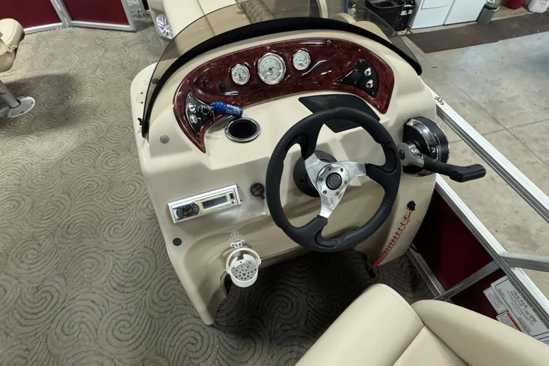 Slide: The Image of 2014 Sun Tracker Party Barge 20 DLX helm with steering wheel and control panel. - 9