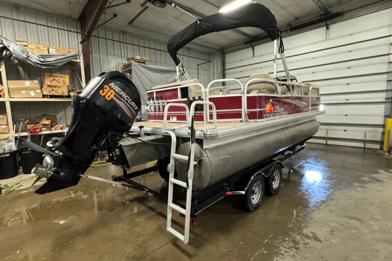 Slide: The Image of 2014 Sun Tracker Party Barge 20 DLX pontoon boat with Mercury 30 engine in a garage. - 3