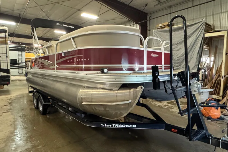 Slide: The Image of 2014 Sun Tracker Party Barge 20 DLX pontoon boat on trailer in indoor storage. - 2