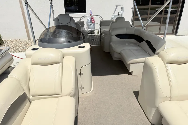 Slide: The Image of The image shows the interior of a 2013 AquaPatio 240 RS with beige leather seating. - 5