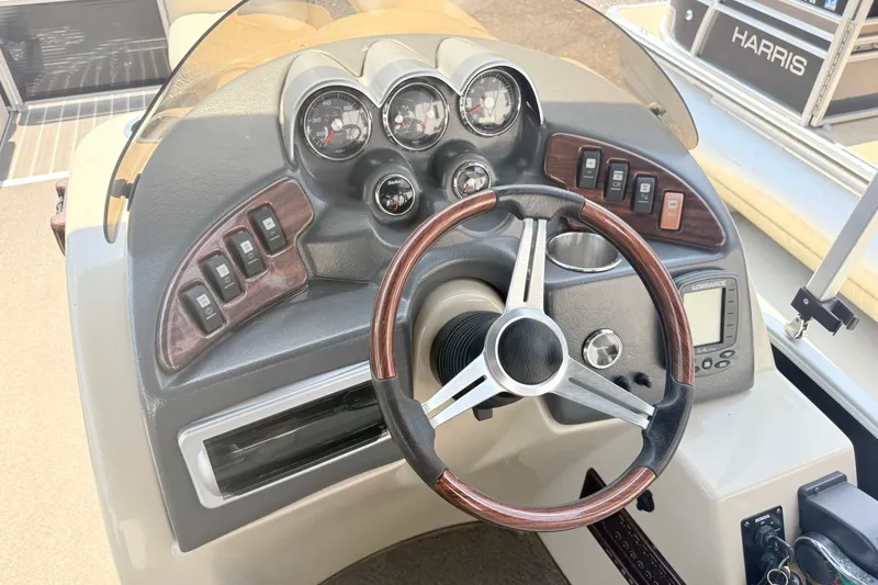 Slide: The Image of Steering console of a 2013 AquaPatio 240 RS boat with gauges and controls. - 8