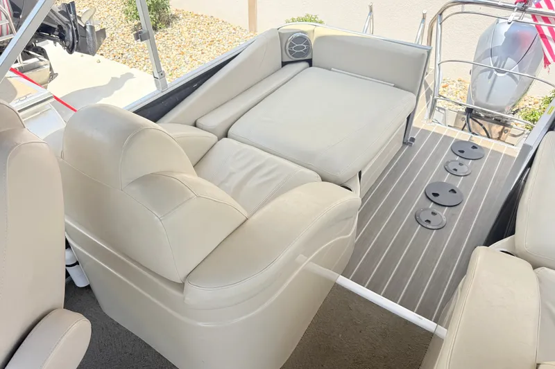 Slide: The Image of 2013 AquaPatio 240 RS boat interior with beige seating and sleek flooring. - 17