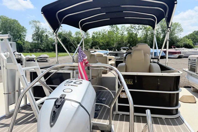 Slide: The Image of 2013 AquaPatio 240 RS pontoon boat with Honda 90 VTEC engine and canopy, docked outdoors. - 1