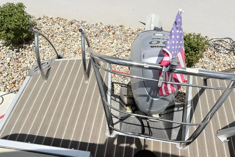 Slide: The Image of AquaPatio 240 RS 2013 boat deck with Honda motor and American flag. - 20