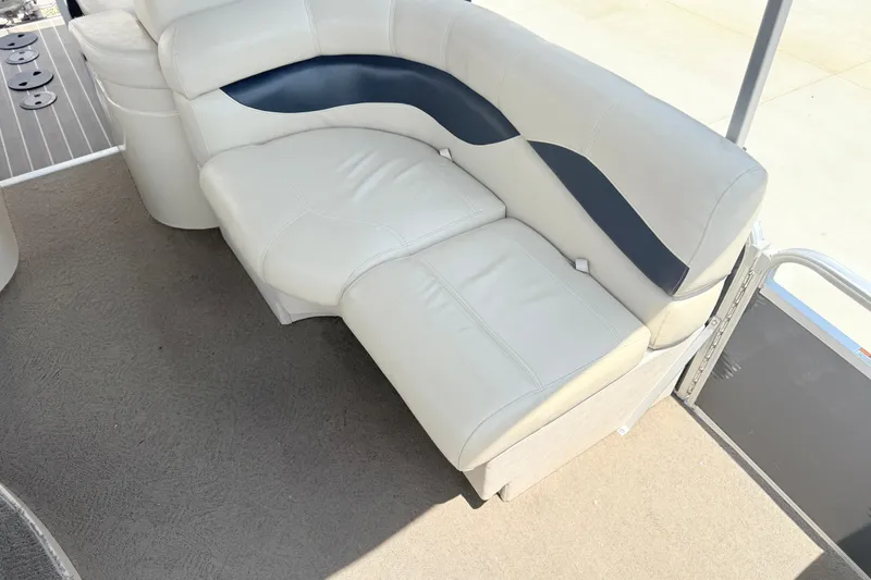 Slide: The Image of The image shows a white leather bench seat on a boat with gray carpet flooring. - 4