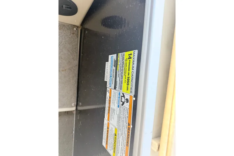 Slide: The Image of Capacity label on 2013 AquaPatio 240 RS boat, indicating maximum 14 persons or 1955 lbs. - 19
