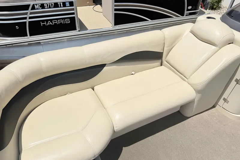 Slide: The Image of Luxurious seating on 2013 AquaPatio 240 RS pontoon boat, featuring cream upholstery. - 15