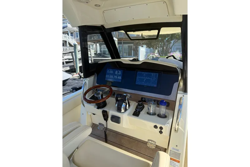 Slide: The Image of 2019 Chris-Craft Catalina 30 helm with modern controls and navigation display. - 4