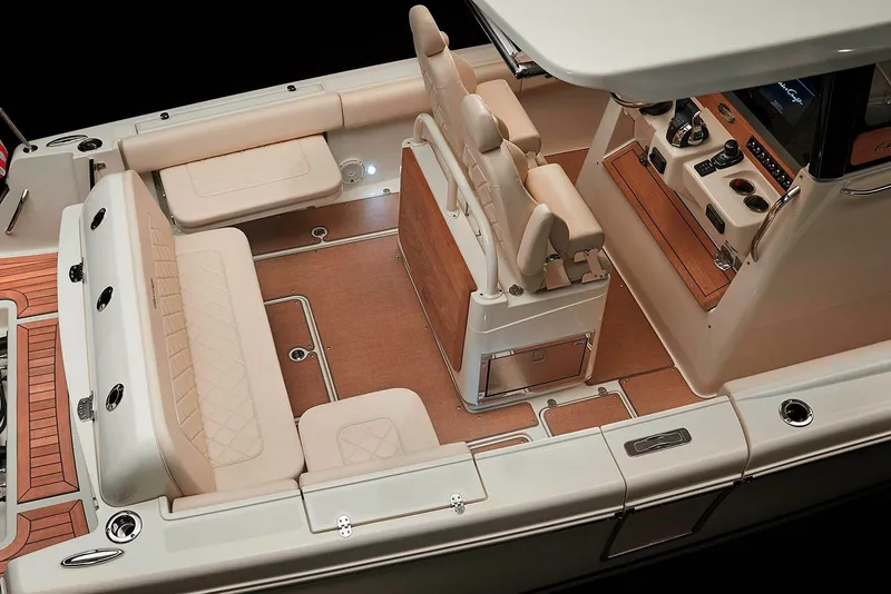 Slide: The Image of Manufacturer Provided Image: 2019 Chris-Craft Catalina 30 boat interior with beige seating and modern dashboard. - 11