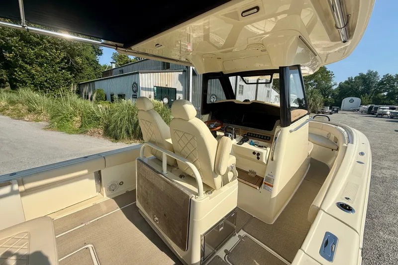 Slide: The Image of 2019 Chris-Craft Catalina 30 boat interior with helm and seating, parked outdoors. - 16