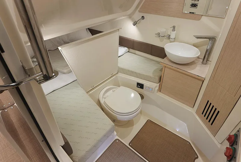 Slide: The Image of Manufacturer Provided Image: 2019 Chris-Craft Catalina 30 bathroom with toilet, sink, and sleeping area. - 13