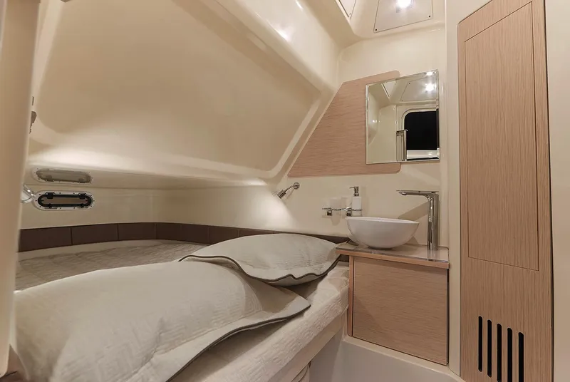 Slide: The Image of Manufacturer Provided Image: 2019 Chris-Craft Catalina 30 cabin interior with bed, sink, and mirror. - 12