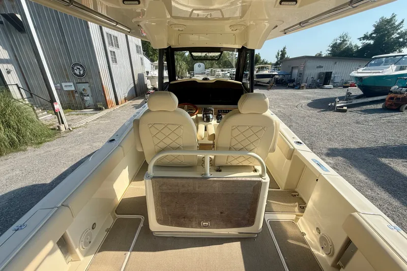 Slide: The Image of 2019 Chris-Craft Catalina 30 boat interior with beige seating and helm station. - 14