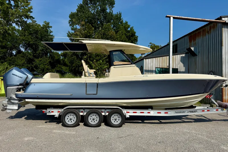 The Image of 2019 Chris-Craft Catalina 30 boat on trailer, featuring sleek design and Mercury engines. - 0