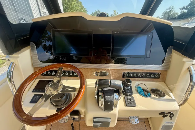 Slide: The Image of Helm of 2019 Chris-Craft Catalina 30 with dual screens and wooden steering wheel. - 17