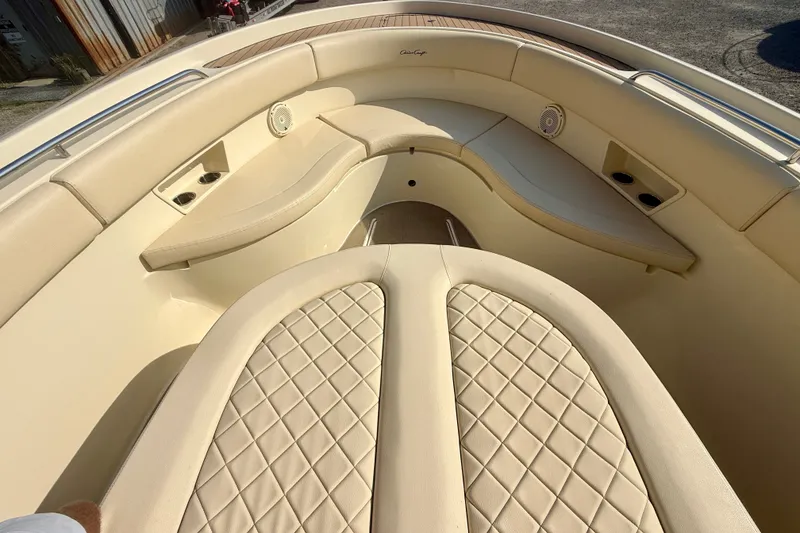 Slide: The Image of 2019 Chris-Craft Catalina 30 boat interior with beige quilted seating and cup holders. - 23