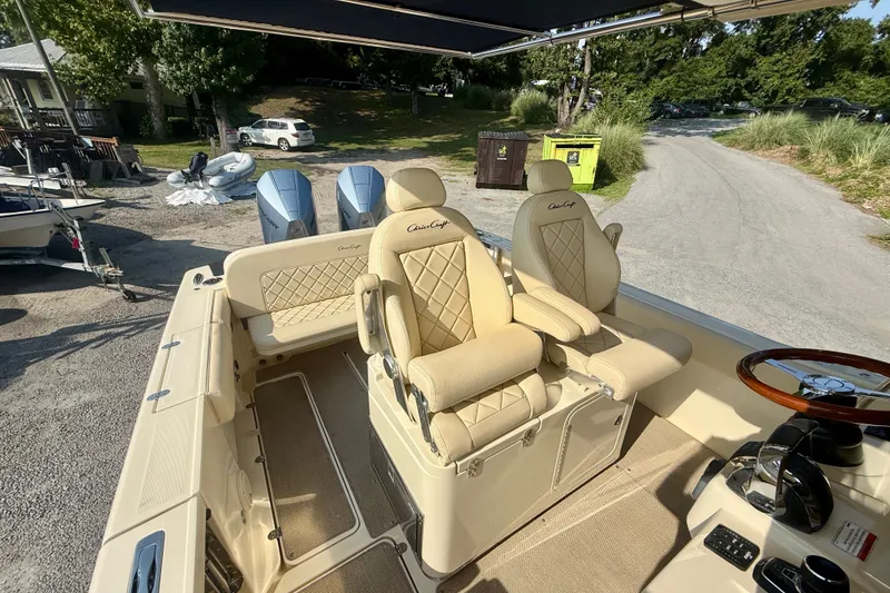 Slide: The Image of 2019 Chris-Craft Catalina 30 boat interior with beige seating and dual outboard motors. - 19