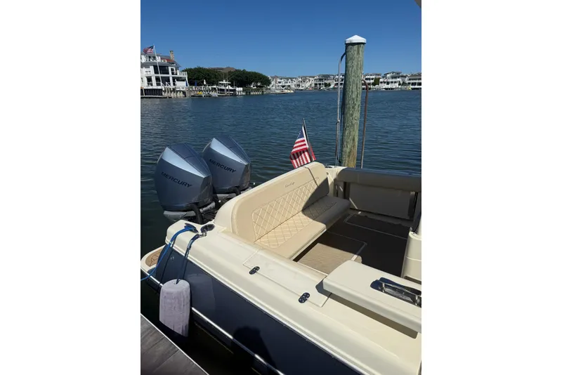 Slide: The Image of 2019 Chris-Craft Catalina 30 docked, featuring dual Mercury engines and American flag. - 2