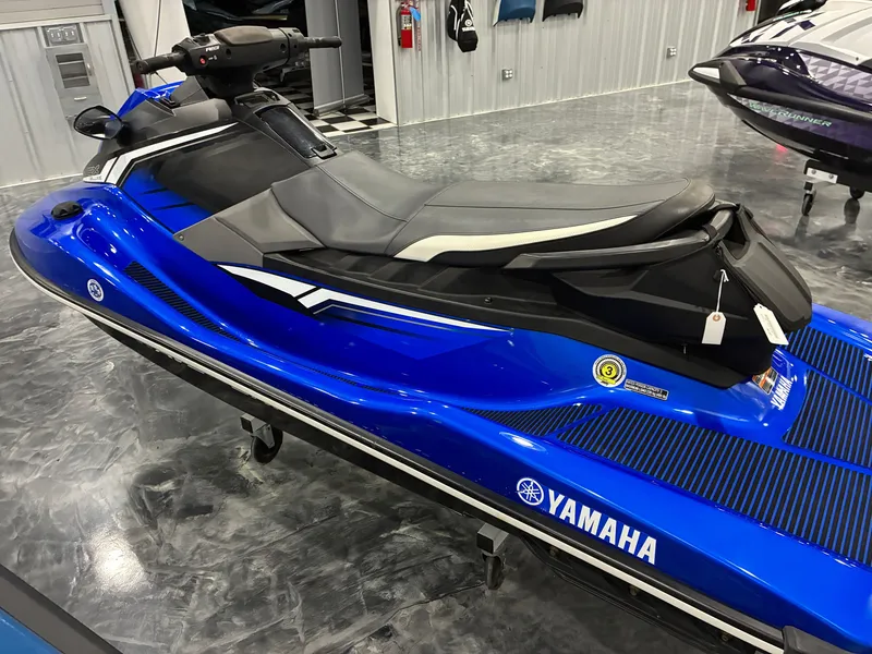 Slide: The Image of A blue 2018 Yamaha EX Deluxe jet ski is displayed in a showroom. - 3